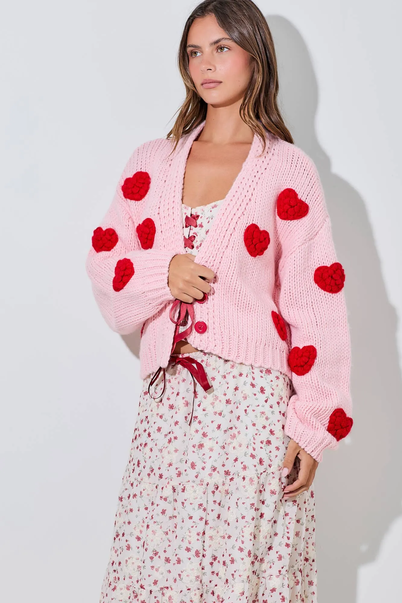 PINK KNITTED CARDIGAN WITH RED BUBBLE HEART DETAIL